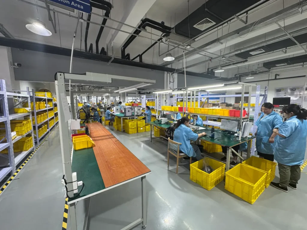 OUKETECH cable assembly workshop with operators, workstations and organized material bins